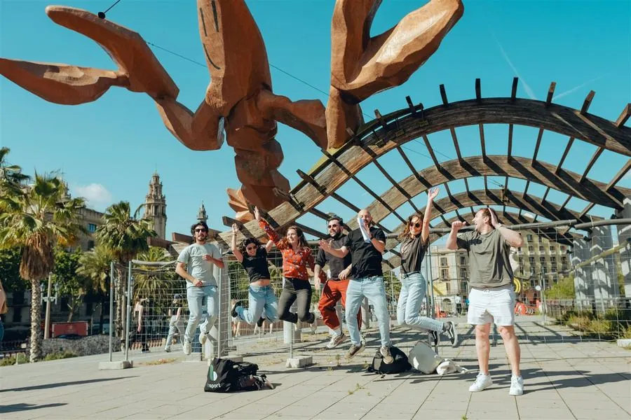 A group celebrating under the giant sculpture