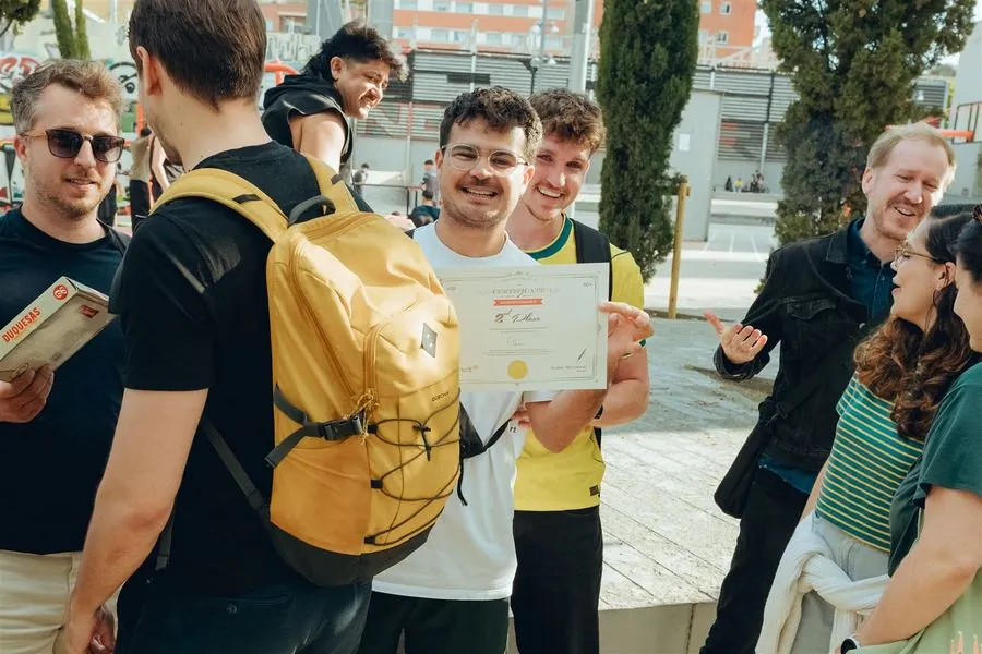 A team member proudly holding a 2nd place certificate