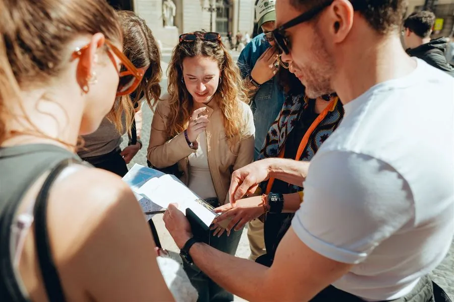 A team gathered around a map and question sheet, working out a clue