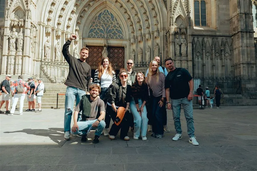 A team celebrating beneath the Cathedral's Gothic archway