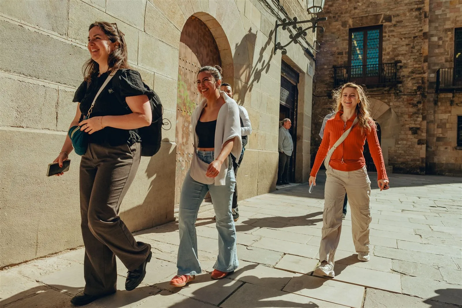 Colleagues laughing together while walking through the Gothic Quarter