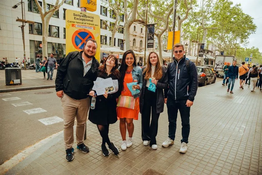 A team posing together on La Rambla with their clue book