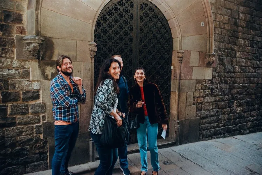 A couple pausing by a colorful Gothic Quarter mural