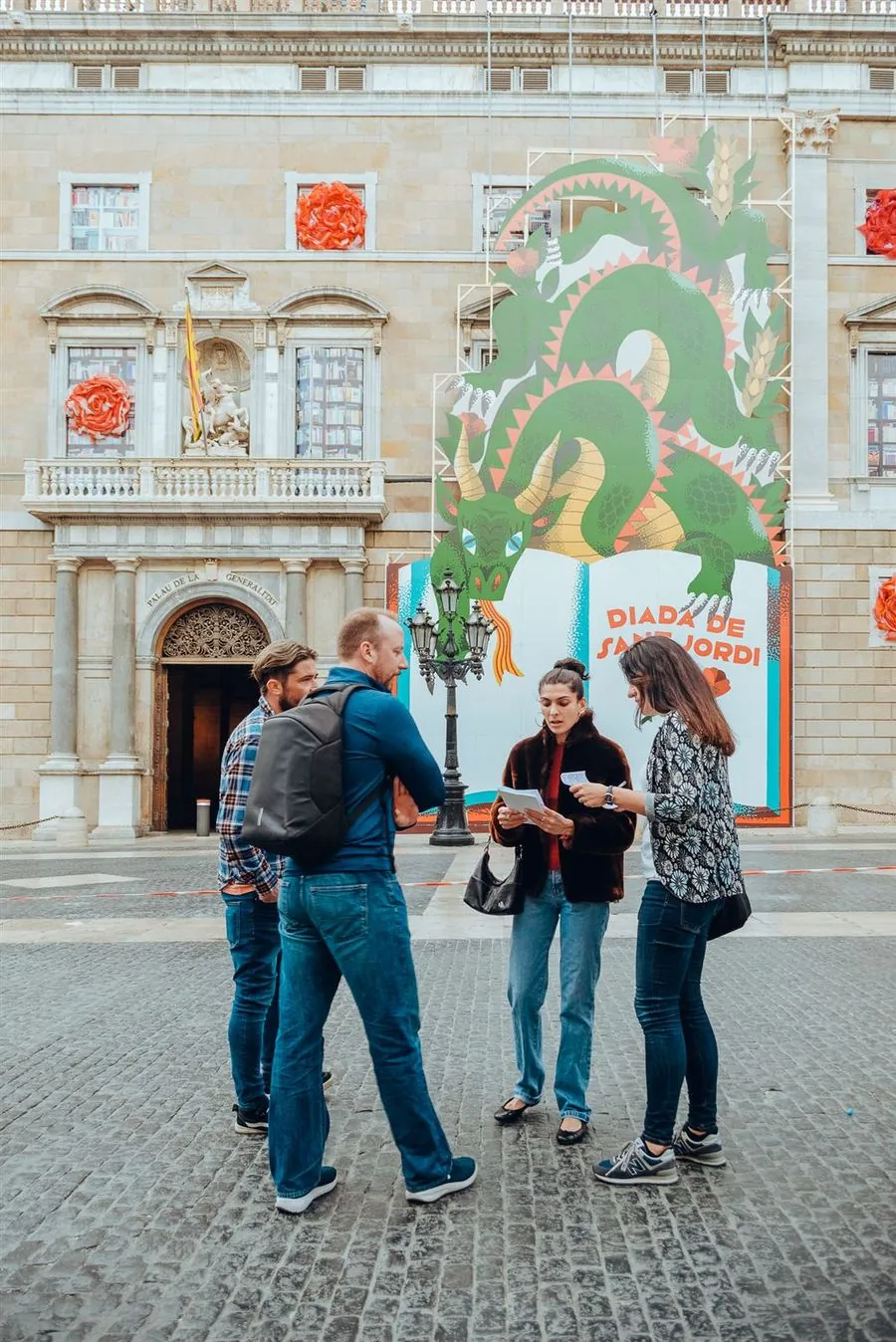 A team dancing in front of a colorful mural